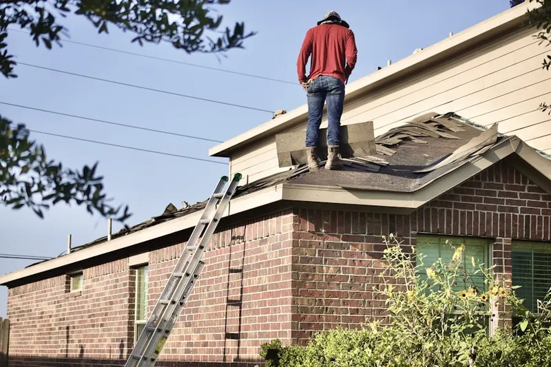 Professional roofer working on a residential roof in Camp Springs
